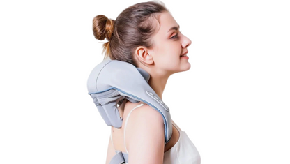Woman using a neck and shoulder massager on a white background