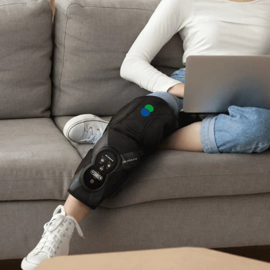 Person using ergonomic SP!NECK knee massager on sofa, wellness and recovery device